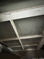 Full view of window sash showing 3x2 section of the 3x3 grid, chipped paint and intact glass