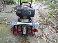 Front view showing tines, shield, engine housing