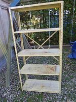 Full view of 4-tier shelving unit outdoors