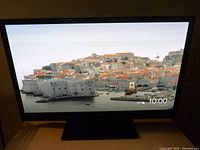 Front view of TV displaying image, stand visible