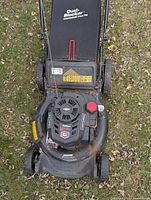 Top view of mower showing engine, label 7.25 HP, missing carb cover