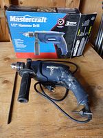 Drill with cord, side handle, depth rod and box