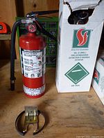 Loose extinguisher, boxed extinguisher, mounting bracket visible