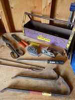 Overall lot showing toolbox and assorted hand tools on workbench