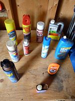 Group shot of assorted cans, bottles and jug on workbench