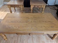 Top view of coffee table and end tables showing wood grain, drawers, leg style