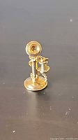 Front view of 14K gold candlestick telephone pendant