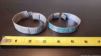 Both bracelets beside measuring tape showing diameter