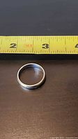 Ring beside tape measure showing diameter ~20 mm