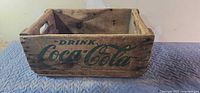 Full view of Coca-Cola wooden crate front side showing logo and structure