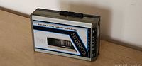 Front view showing AM/FM radio cassette player branding and tape window