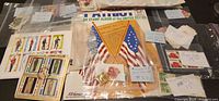Overall lot showing Patriot album and multiple packets of stamps