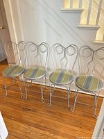 All four wrought iron ice cream chairs in a row