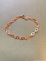 Full view of bracelet showing daisy link design and clasp