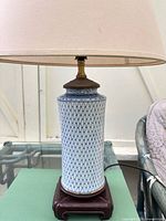 Full lamp showing porcelain body, wood base and shade