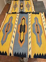 Large and small kilim cushion covers displayed flat to show full pattern and relative sizes