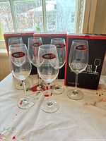 Front view of six Riedel Ouverture champagne glasses and three retail boxes