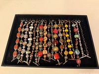 Tray of 18 beaded toggle bracelets, full view