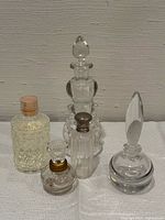 Group shot of all five clear glass perfume bottles