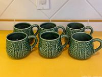 Six green cabbage pattern mugs front view
