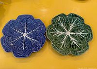 Both cabbage-leaf plates, green and blue, top view