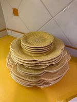 Stack showing all sizes of yellow cabbage leaf plates