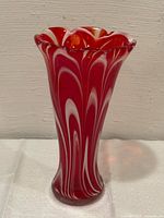 Full view of vase front showing red and white swirl pattern and overall shape