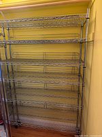 Full view of chrome wire shelving unit with six shelves and casters