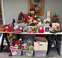 Overall view of two-tier tabletop filled with assorted vintage Christmas decorations