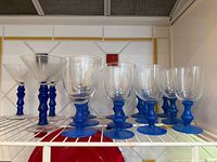 Group of goblets and cocktail glasses on shelf