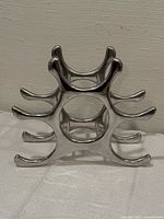 front view of aluminum wine rack showing curved cradle arms