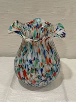 Front view showing multicolor splatter design and ruffled rim