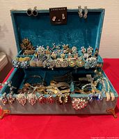 Open jewelry chest showing full assortment of rhinestone costume jewelry