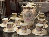 full set showing pot, cups and saucers on display
