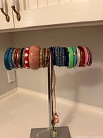 Full view of display stand with all bangles and two necklaces