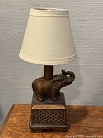 Full view of bronze elephant table lamp with shade