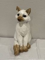 Front view of carved wooden cat figurine