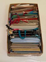 Top view of box showing layered cards wrapped with ribbon and trims