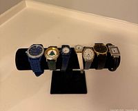 Full view of seven watches on stand
