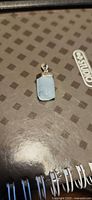 Front view of aquamarine pendant showing gemstone and silver cap