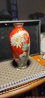 Front view of red cloisonné vase with chrysanthemum design