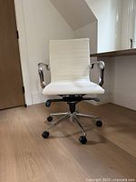 Front view of white ribbed swivel office chair on chrome base