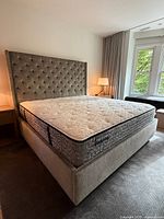 Full view of king upholstered platform bed frame with mattress to illustrate overall design and scale