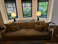 Front view of sofa positioned against bay window