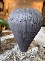 Front view of Loren Kaplan ceramic vase showing leaf rim and fluted body