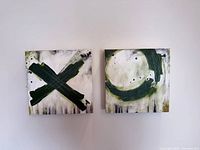 Both canvases hung side by side showing X and O compositions