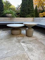Pair of West Elm Tambor concrete side tables on patio