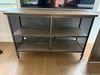 Front view showing four shelves and metal frame