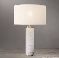 Stock image of Restoration Hardware Carrara marble cylindrical table lamp with linen drum shade