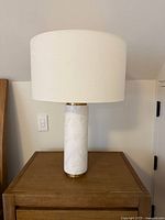 Actual lamp on wooden nightstand showing full view